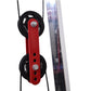 Red and black dual pulley system with metal fasteners attached to cable rack on white background