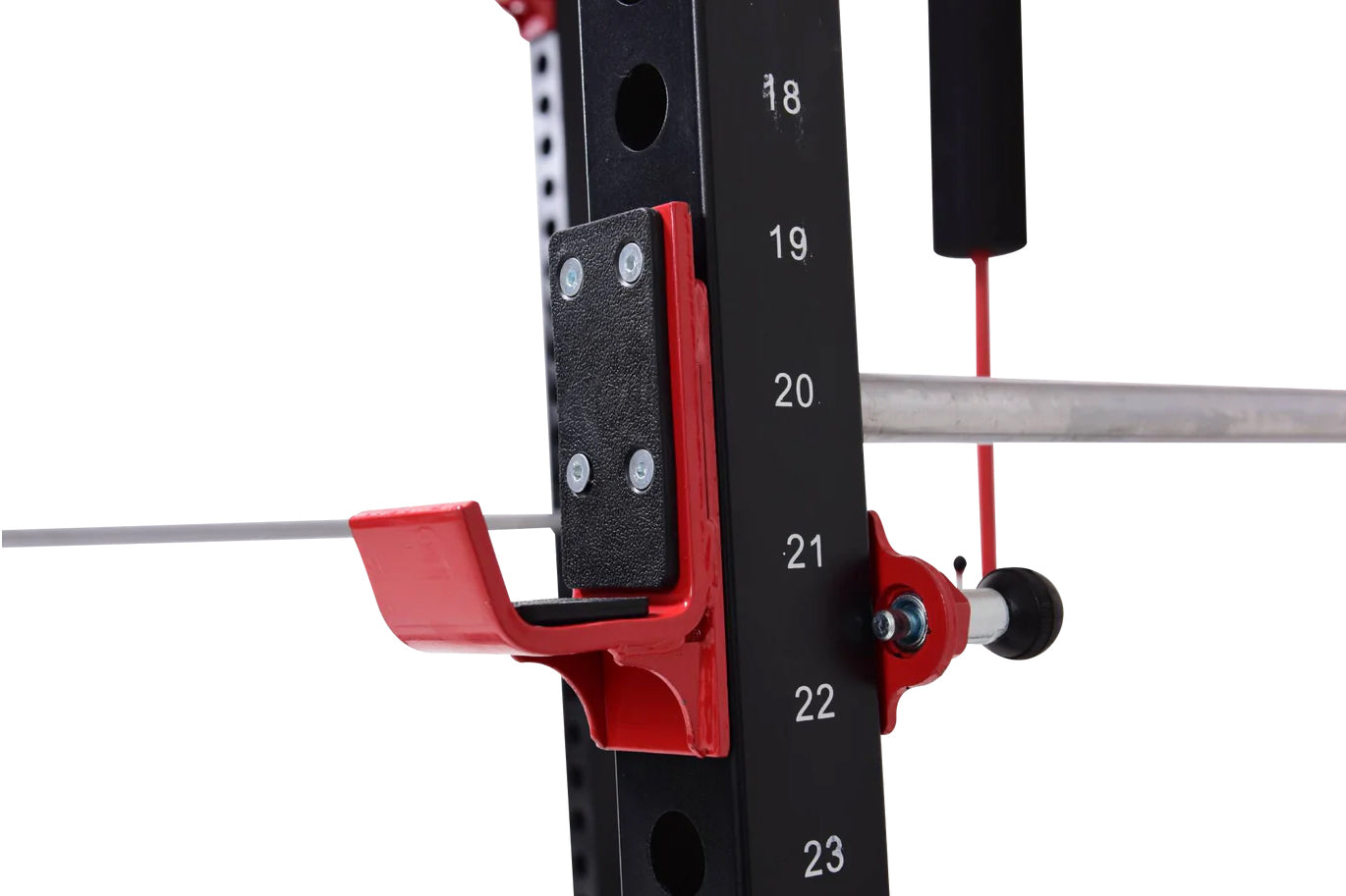 Red and black cable pulley attachment with numbered mounting posts on power rack, close-up detail view