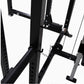 Black steel power rack with cable pulley system, adjustable safety bars, and folding design on white background