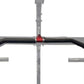 Black curved pull-up bar with red center attachment mounted on gray metal power rack frame