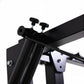 Black and white metal power rack with folding cable pulley system, adjustable height arms, and mounting hardware on white bac