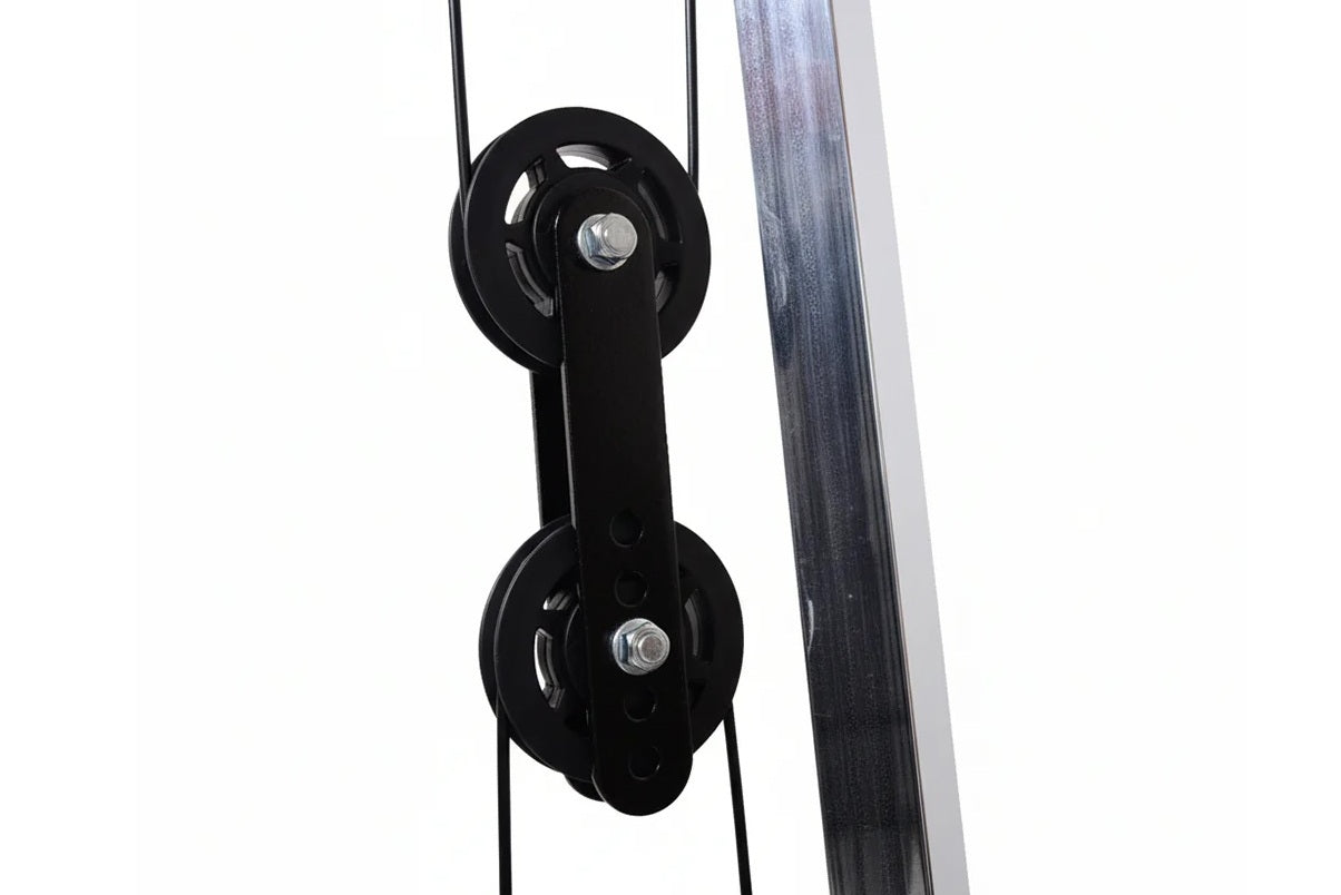 Black double pulley system with cables attached to gray metal frame on white background