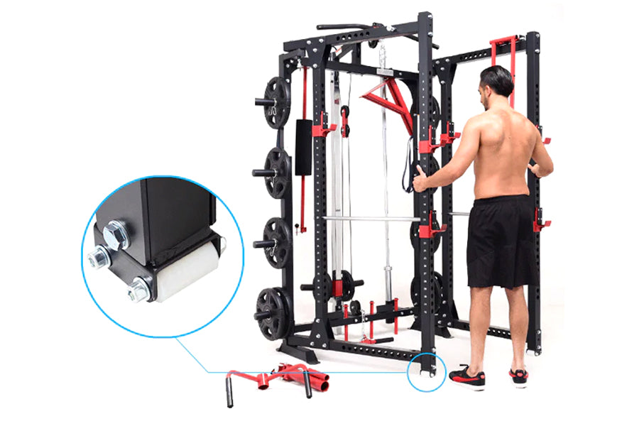 Black and red freestanding power rack with cable pulleys, weight plates, and adjustable arms, shown with shirtless man using 