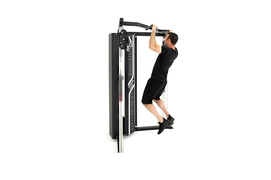 Man in black workout clothes using black cable pulley functional trainer with dual arms on white background