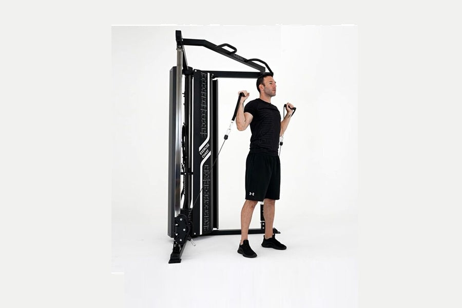 Man using black cable pulley functional trainer with dual adjustable arms on white background