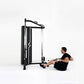 Man using black and silver cable pulley functional trainer machine with dual adjustable pulleys on white background