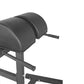 Black padded leg extension machine with cylindrical foam rollers and metal frame on white background