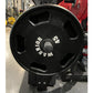 Black Olympic weight plate with grip handles and white text reading "Warrior" and "25 lb", displayed in gym setting