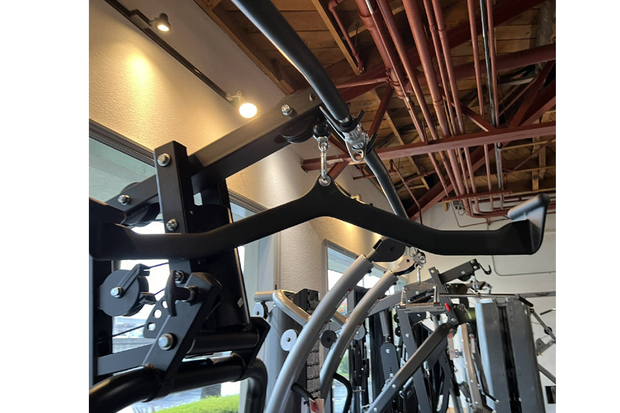 Black Warrior HG900 home gym with leg press attachment mounted on ceiling in industrial setting