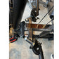 Warrior HG900 home gym leg press attachment with black metal frame, brown seat, and red pedal on concrete floor