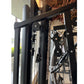 Warrior HG900 home gym with black frame and leg press attachment, showing metal components and adjustment mechanisms