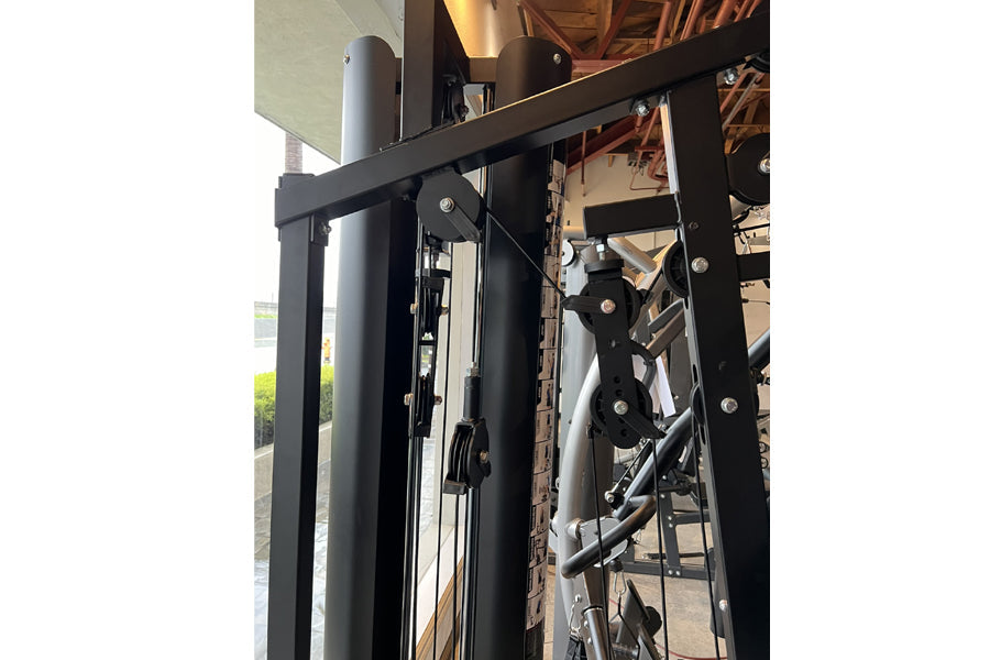 Warrior HG900 home gym with black frame and leg press attachment, showing metal components and adjustment mechanisms