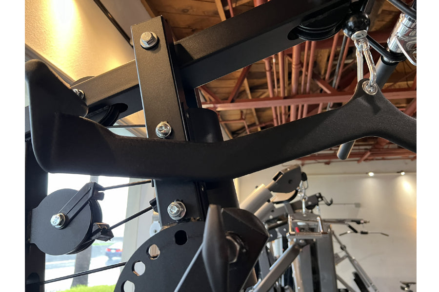 Warrior HG900 home gym with black metal frame, leg press attachment, and cable pulleys on display