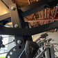 Warrior HG900 home gym with black frame and metal components, showing leg press attachment and weight plate holder in indoor 