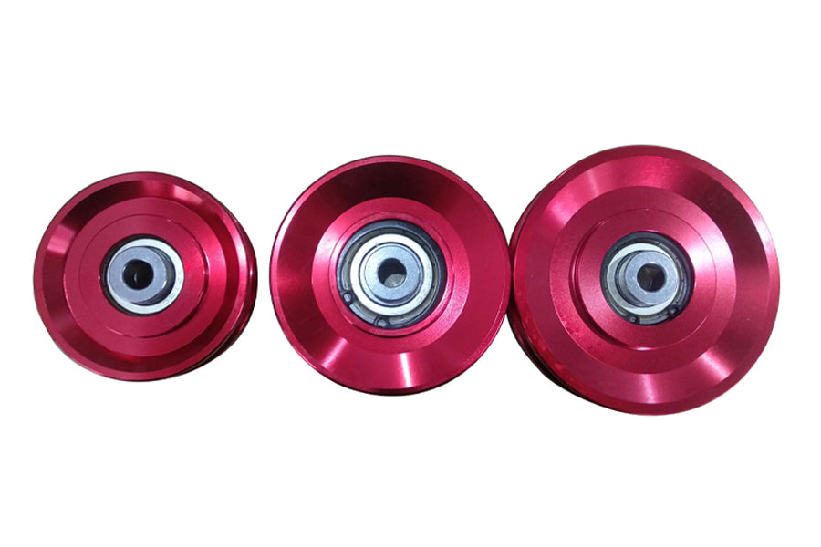 Three metallic pink skateboard wheels with steel ball bearings on white background