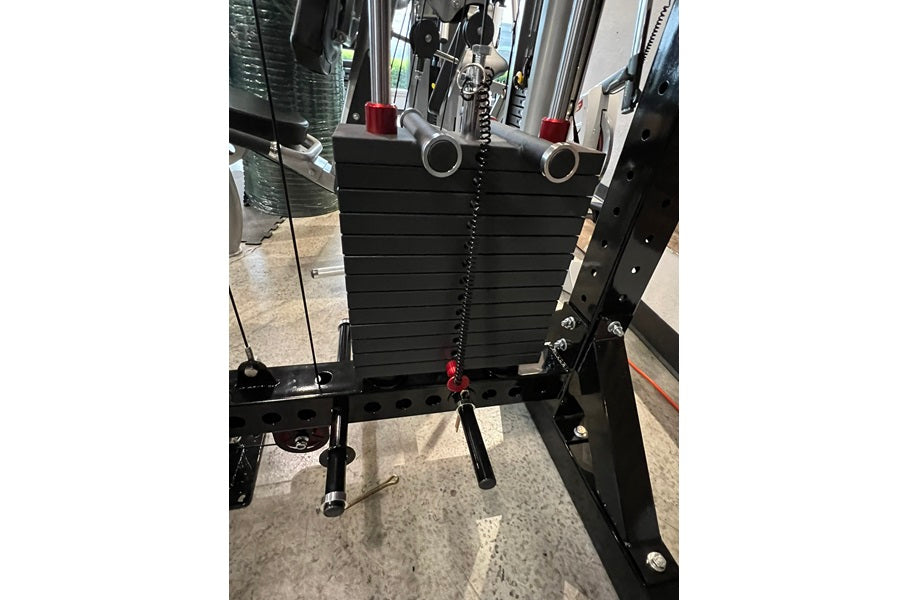 Black weight plate storage system with horizontal sled attachment, red handles, and chain cable, viewed from front on concret