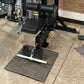 Black and silver lat pulldown and low-row home gym machine with padded seat, dual cylindrical handles, and textured base plat
