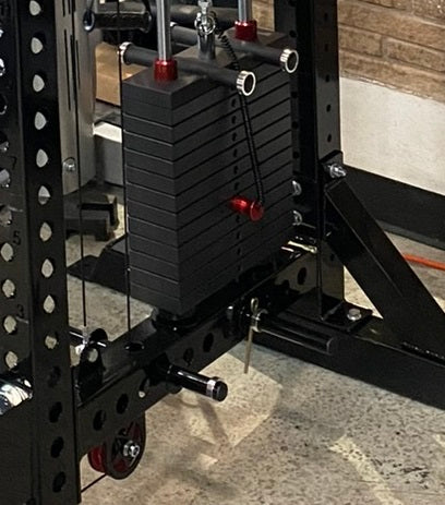Black lat pulldown and low-row home gym system with stacked weight plates, red adjustment knobs, and cable attachments mounte