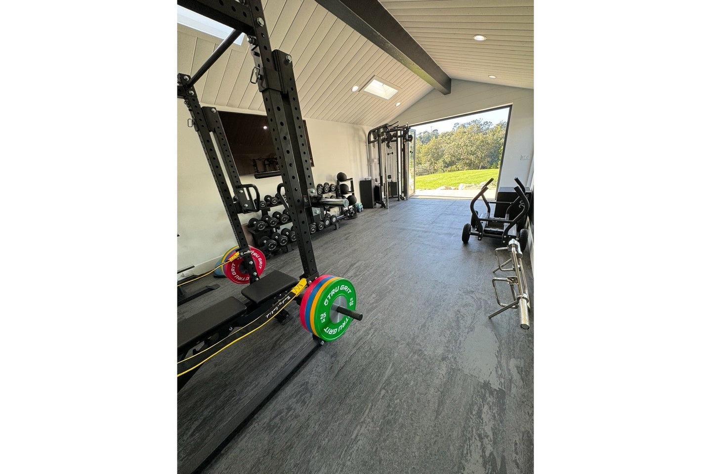 Warrior Marble Interlocking Tile Gym Flooring in Cloud Grey installed in modern home gym with equipment