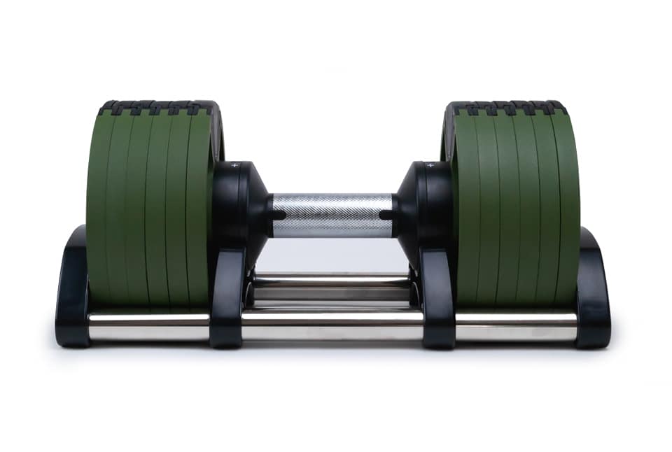 Adjustable dumbbell with green weight plates and chrome bar on black base, shown on white background