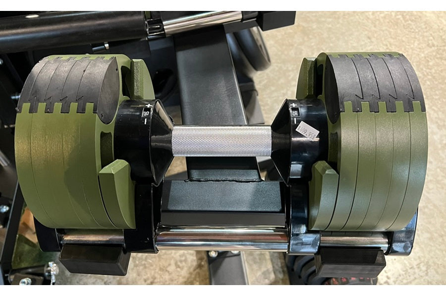 Pair of adjustable dumbbells with olive green weight plates and chrome handle, mounted on black base stand