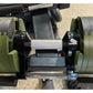 Adjustable dumbbell with olive green plates and black metal handle on stand, front view