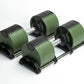 Pair of green and black adjustable dumbbells with weight plates and chrome handles on white background