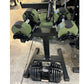 Warrior Newbell adjustable dumbbells set with olive green and black weights, displayed on black weight stand with pair of dar