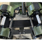 Adjustable dumbbells with sage green and black weight plates, chrome handles, on black metal weight rack, flat lay view