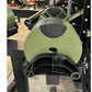 Sage green and black adjustable dumbbell weight shown from front angle in gym setting