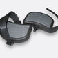 Black oversized platform pedals with gray textured surfaces and adjustable straps on white background