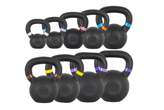 Set of nine black powder-coated kettlebells with colored weight bands in increments from 4kg to 24kg, displayed on white back