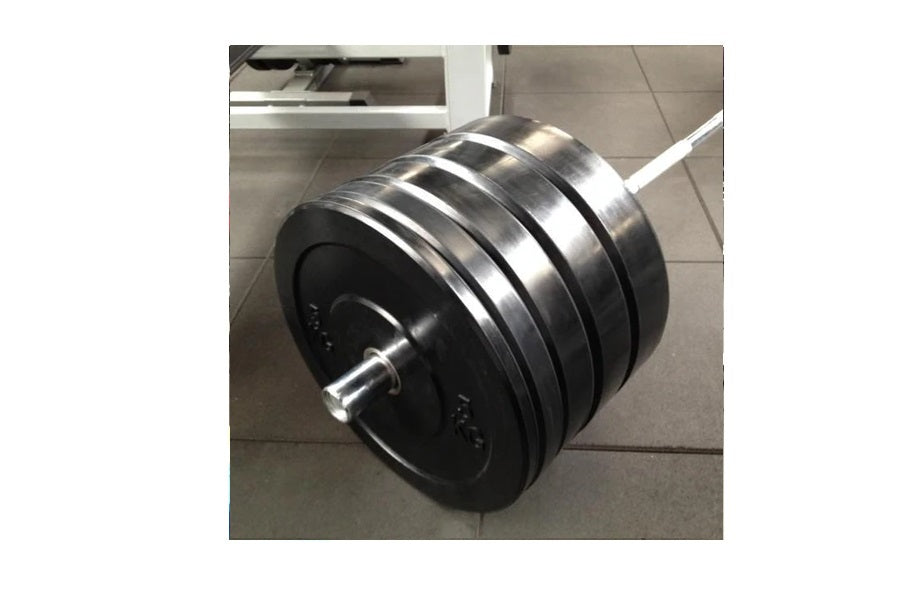 Warrior Premium Olympic Bumper Plates with black rubber discs and chrome-plated steel bar, displayed on gray floor