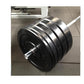 Black rubber bumper plates with chrome barbell bar on gray tile floor