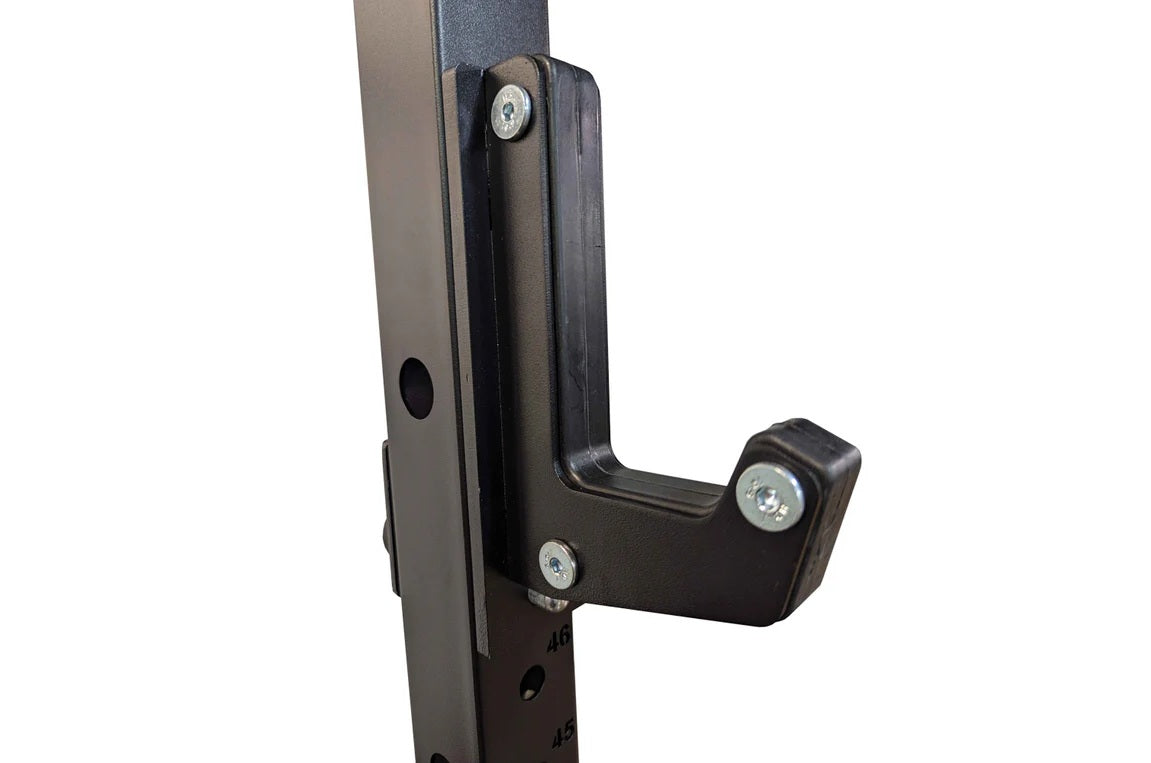 Black steel power rack corner bracket with chrome bolts, mounted on vertical post