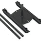 Black metal sled frame with square base, vertical post, and adjustable handles with two cylindrical weight tubes on white bac
