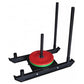 Warrior Pro Push/Pull Weight Sled with red and green circular weight plate, black frame, and four adjustable antenna-style ha