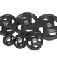 Set of six black rubber grip Olympic weight plates with metal centers, flat lay on white background