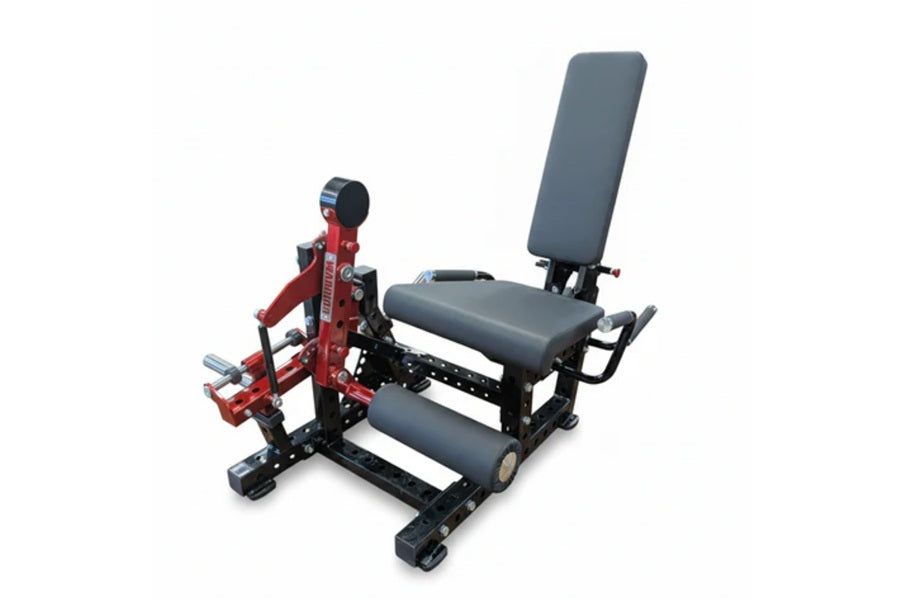 Warrior Signature commercial plate-loaded leg extension and prone leg curl machine with red frame and gray padding, on white 