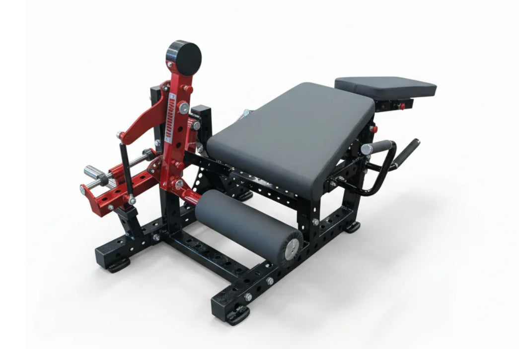 Red and black plate-loaded leg extension and prone leg curl machine with gray padded seat and footrest on white background