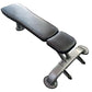 Warrior flat weight bench with black padded seat and backrest, silver metal frame with leg extension attachment, on white bac