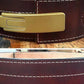Dark brown leather belt with brass buckle, white contrast stitching, and embossed details, shown front and interior views