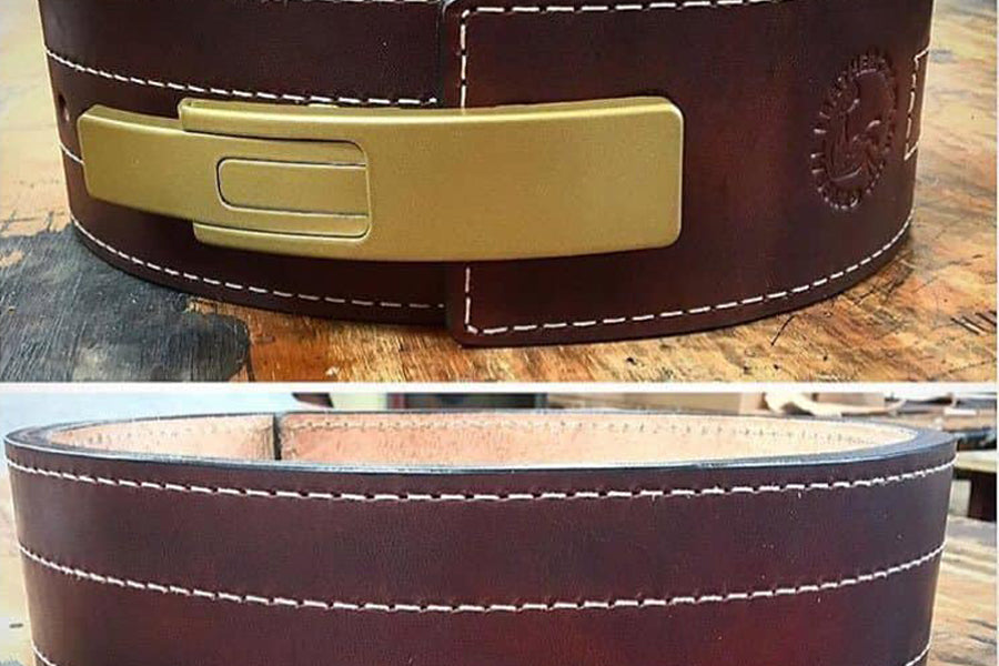 Dark brown leather belt with brass buckle, white contrast stitching, and embossed details, shown front and interior views
