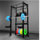 Black modular power rack with pull-up bar, blue barbell with weights loaded, storage shelves holding dumbbells and colored we