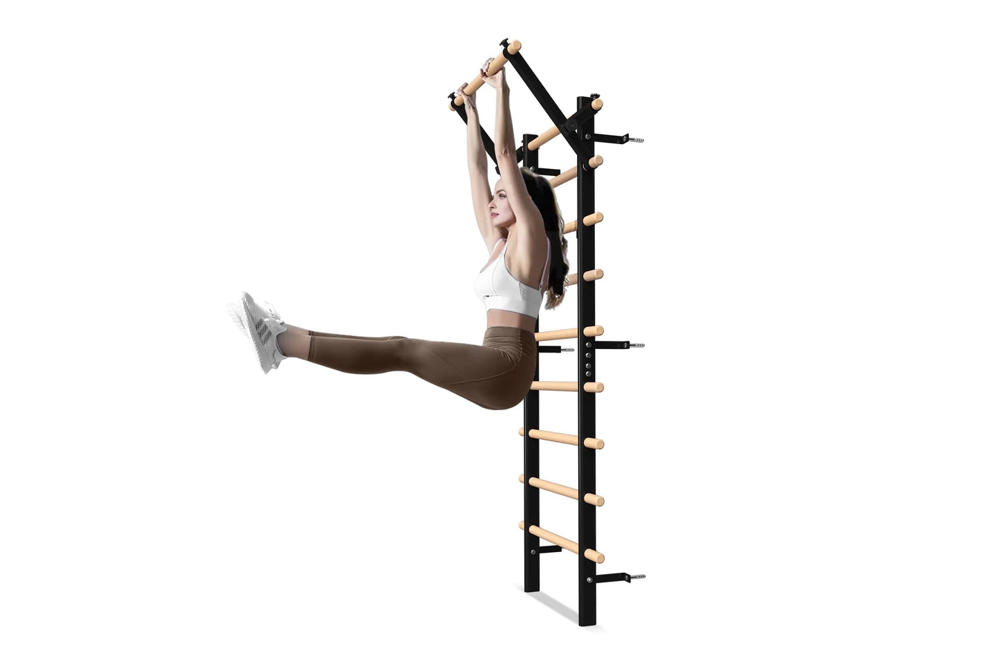 Black and natural wood wall-mounted Swedish stall bars with horizontal wooden rungs, shown in use by model wearing white spor