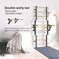 Double wally bar with black metal frame and natural wood rungs, adjustable height, displayed in bedroom setting next to bed w