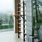 Black metal and natural wood wall-mounted ladder bar with horizontal rungs, installed against brown wood paneling in modern i
