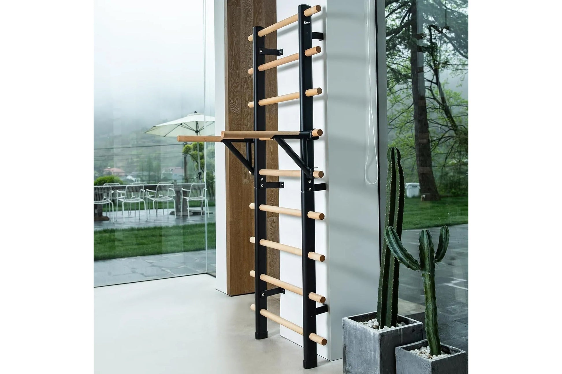 Black metal and natural wood wall-mounted ladder bar with horizontal rungs, installed against brown wood paneling in modern i