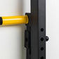 Yellow and black wall-mounted squat rack pull-up bar with black metal frame mounted on white wall