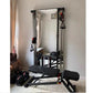 Black steel wall-mounted cable pulley gym system with dual weight stacks, mirror, and adjustable bench in home fitness space